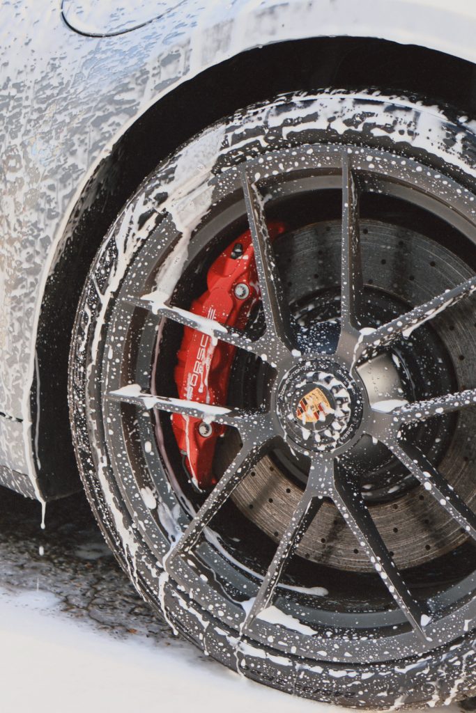 Porsche 911 Carrera GTS wheel in car wash